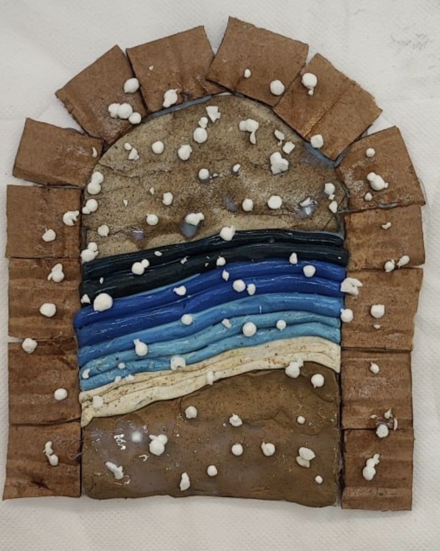 Clay and cardboard arch with a sea scene in shades of blue