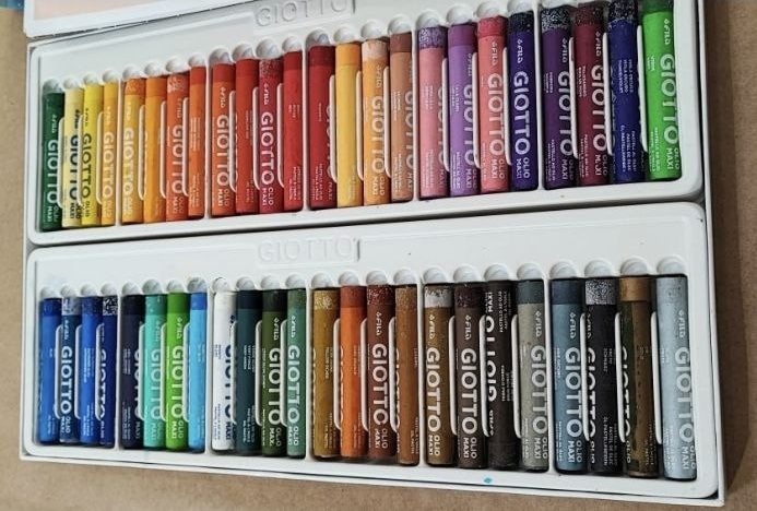 Open box of oil pastels in many colors